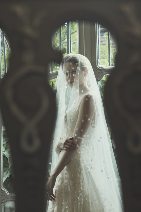 Phillipa Lepley wedding gown with a silk tulle, two-tier, full-length veil with a bespoke design; covered with hand-appliqued Lily Of The Valley petals cascading to the floor.