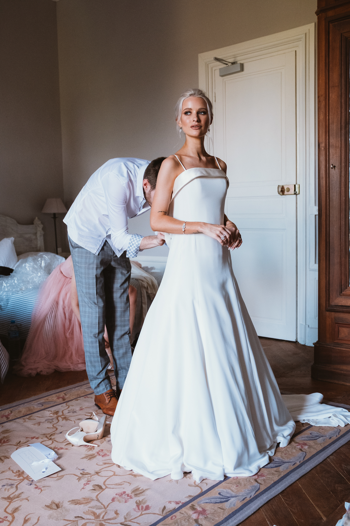 Victoria Magrath of inthefrow stands whilst her Phillipa Lepley wedding gown is buttoned.