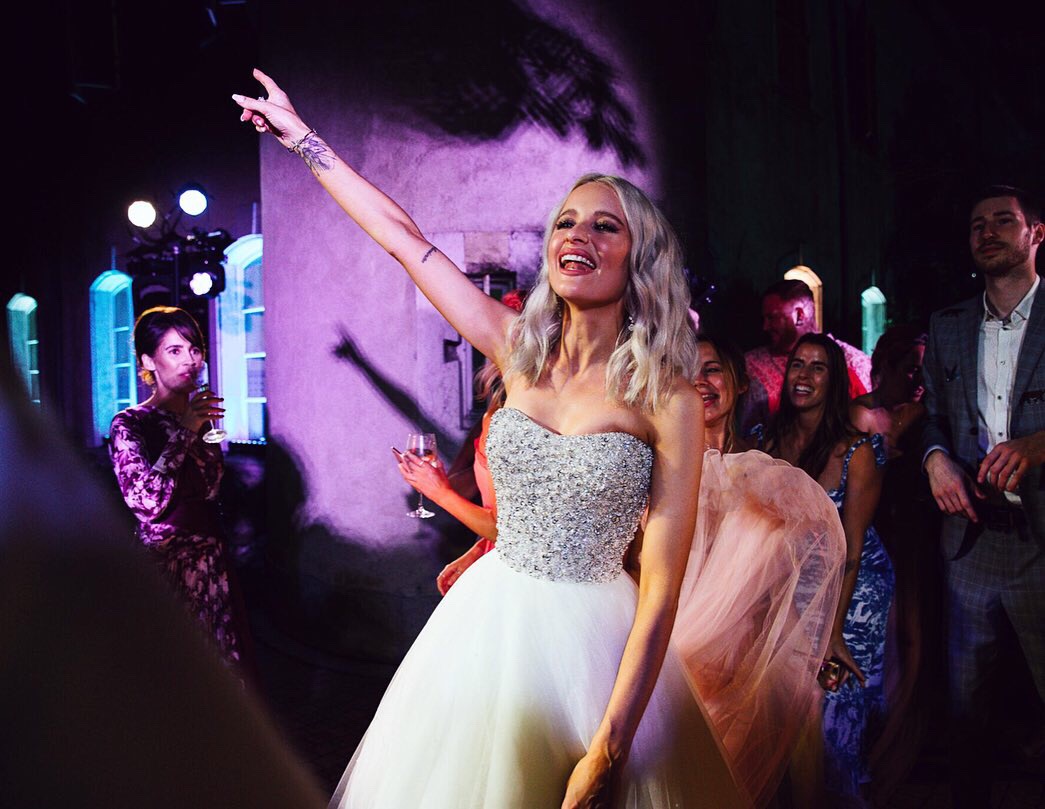 Victoria Magrath of inthefrow stands in her tulle and crystal evening wedding gown designed by Phillipa Lepley at her reception.